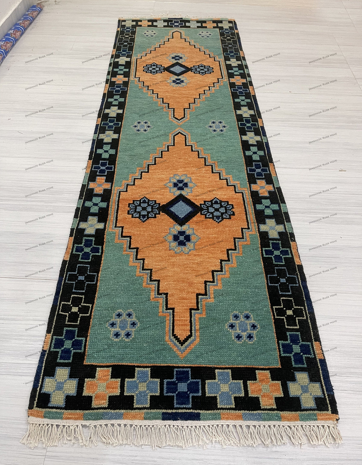 Elegant green area rug with traditional design and soft color tones.