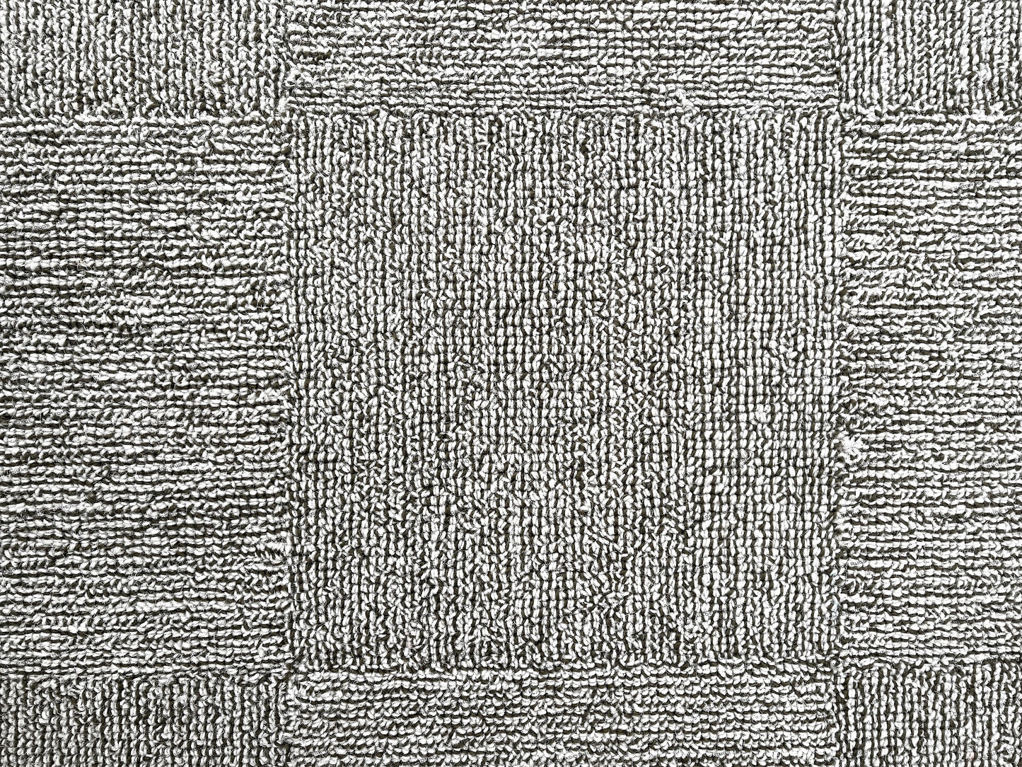 Unique modern rug with hand-tufted patterns in warm and cool tones.