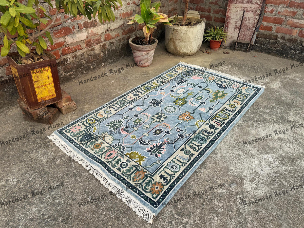 Vintage-inspired Oushak rug with soft teal hues and handwoven charm.