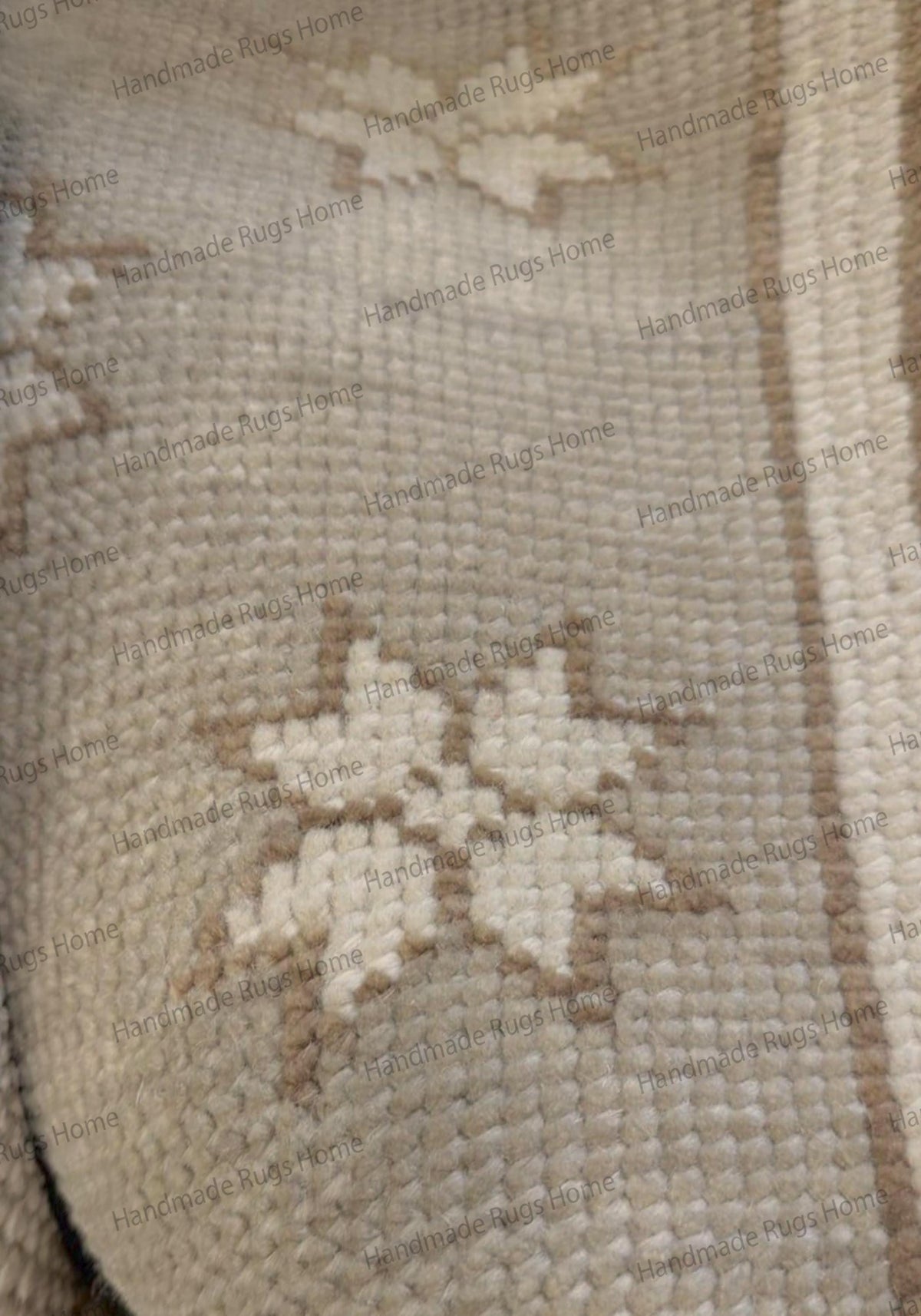 Detailed view of the tight knotting and low pile texture of a handmade star-patterned rug.
