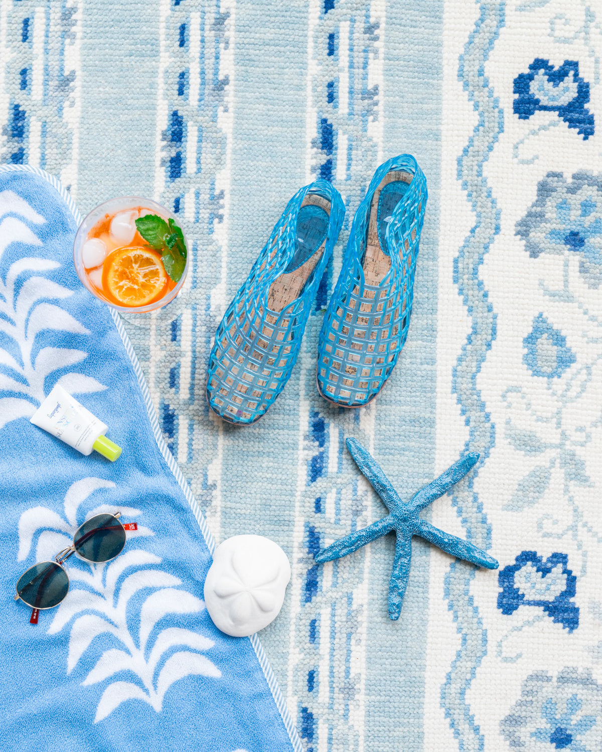 Blue and ivory Modern Oushak rug styled with coastal-inspired décor, blue accessories and beach accents