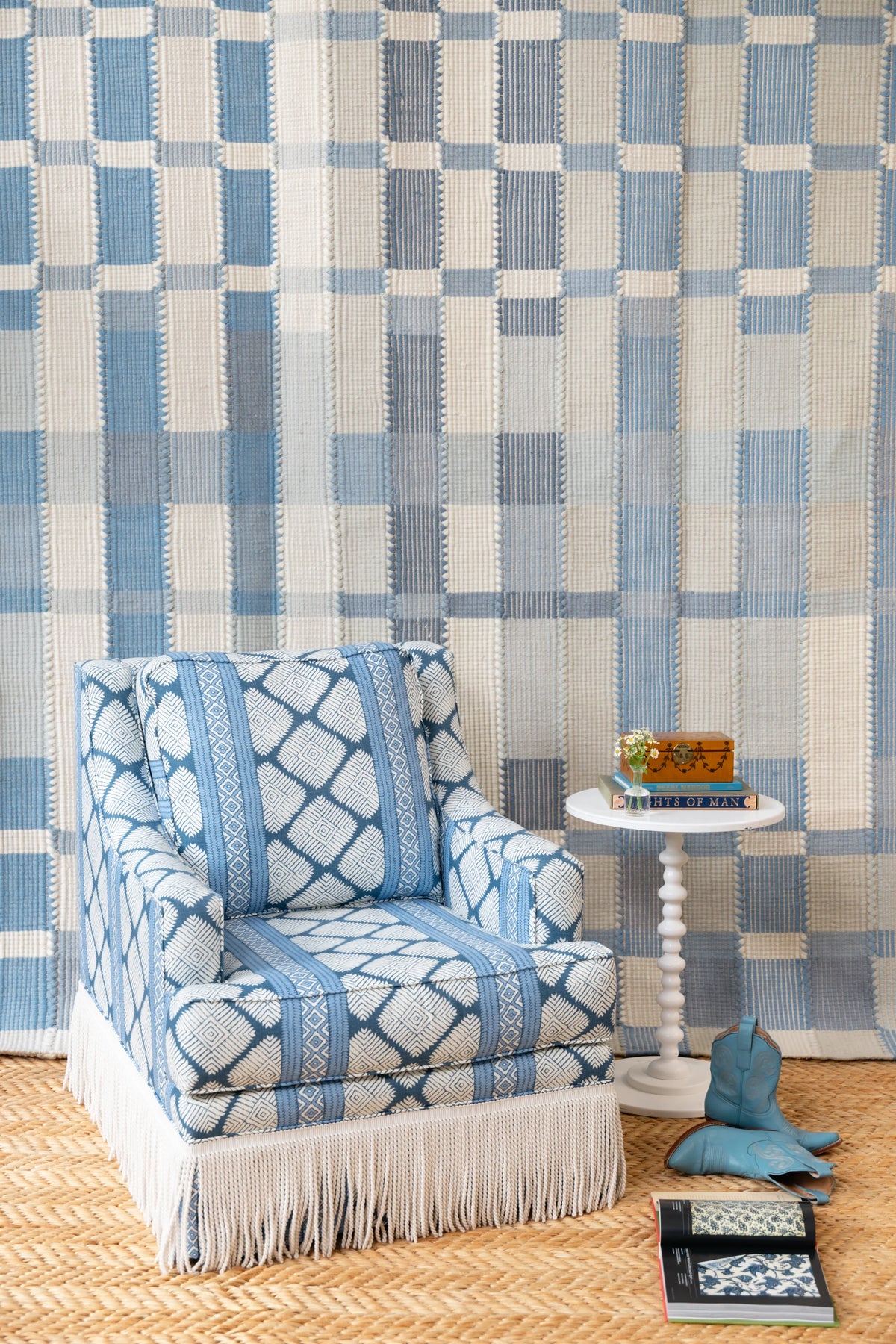 Blue and ivory plaid flatweave rug styled with a patterned blue chair and coastal-inspired interior decor