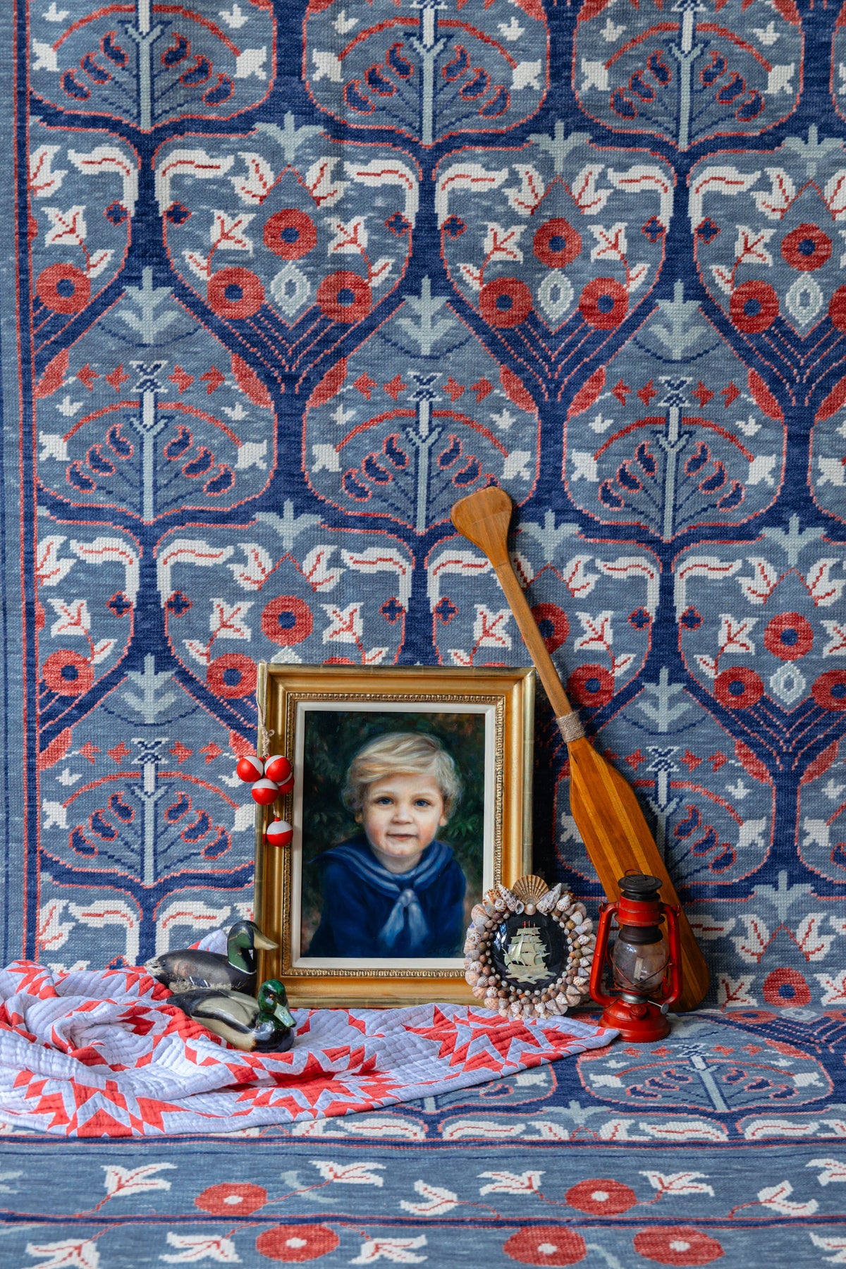 Blue and red Modern Oushak rug with floral botanical pattern styled with Americana and coastal-inspired decor