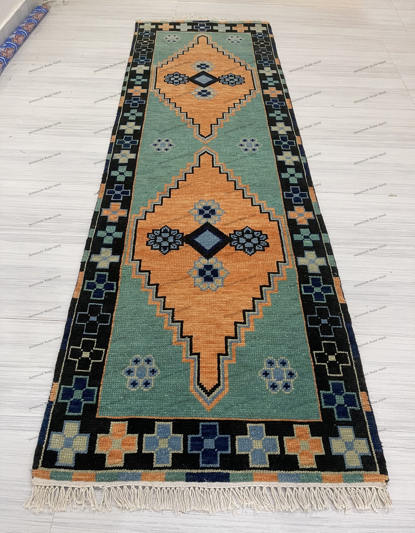 Elegant green area rug with traditional design and soft color tones.