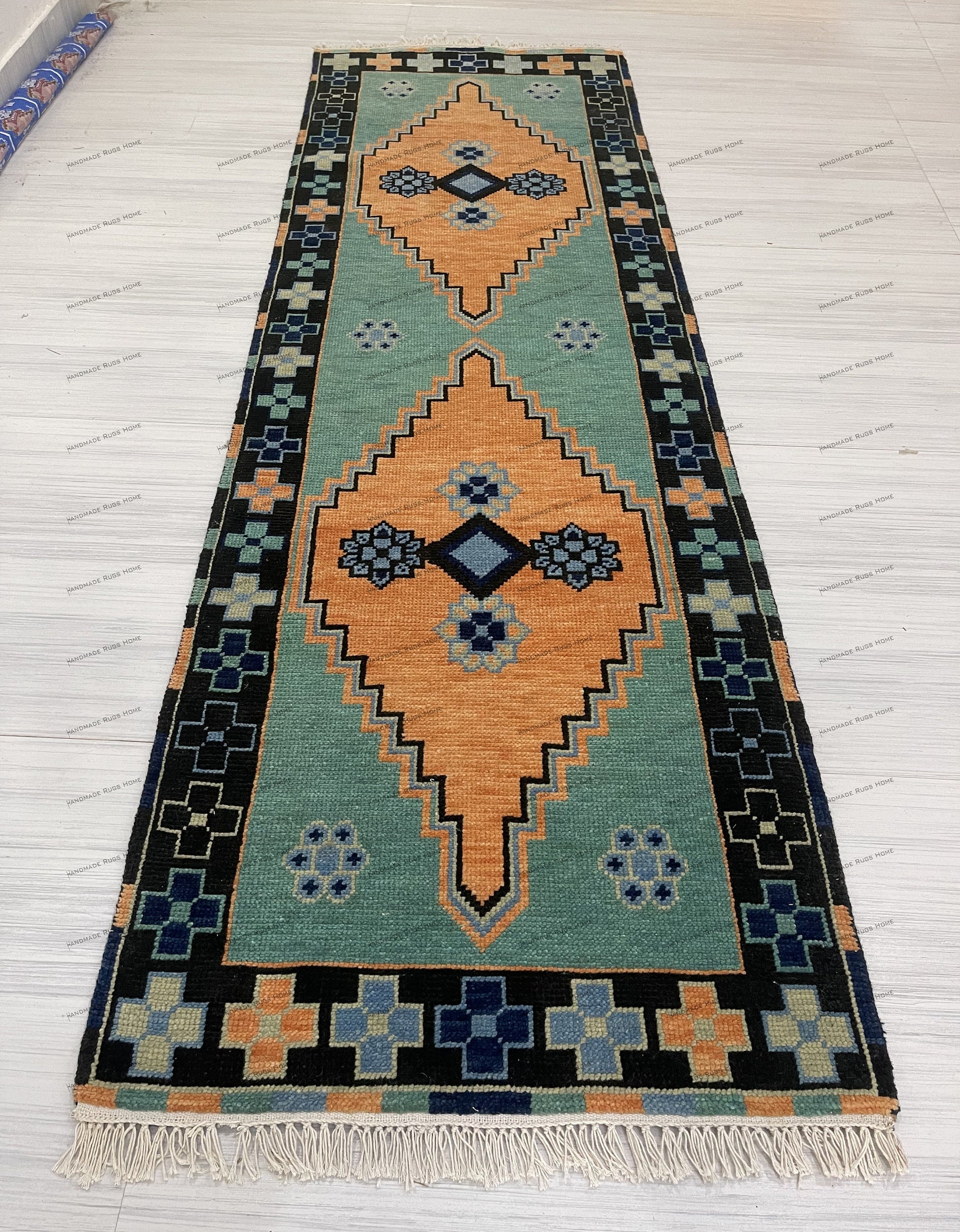 Elegant green area rug with traditional design and soft color tones.