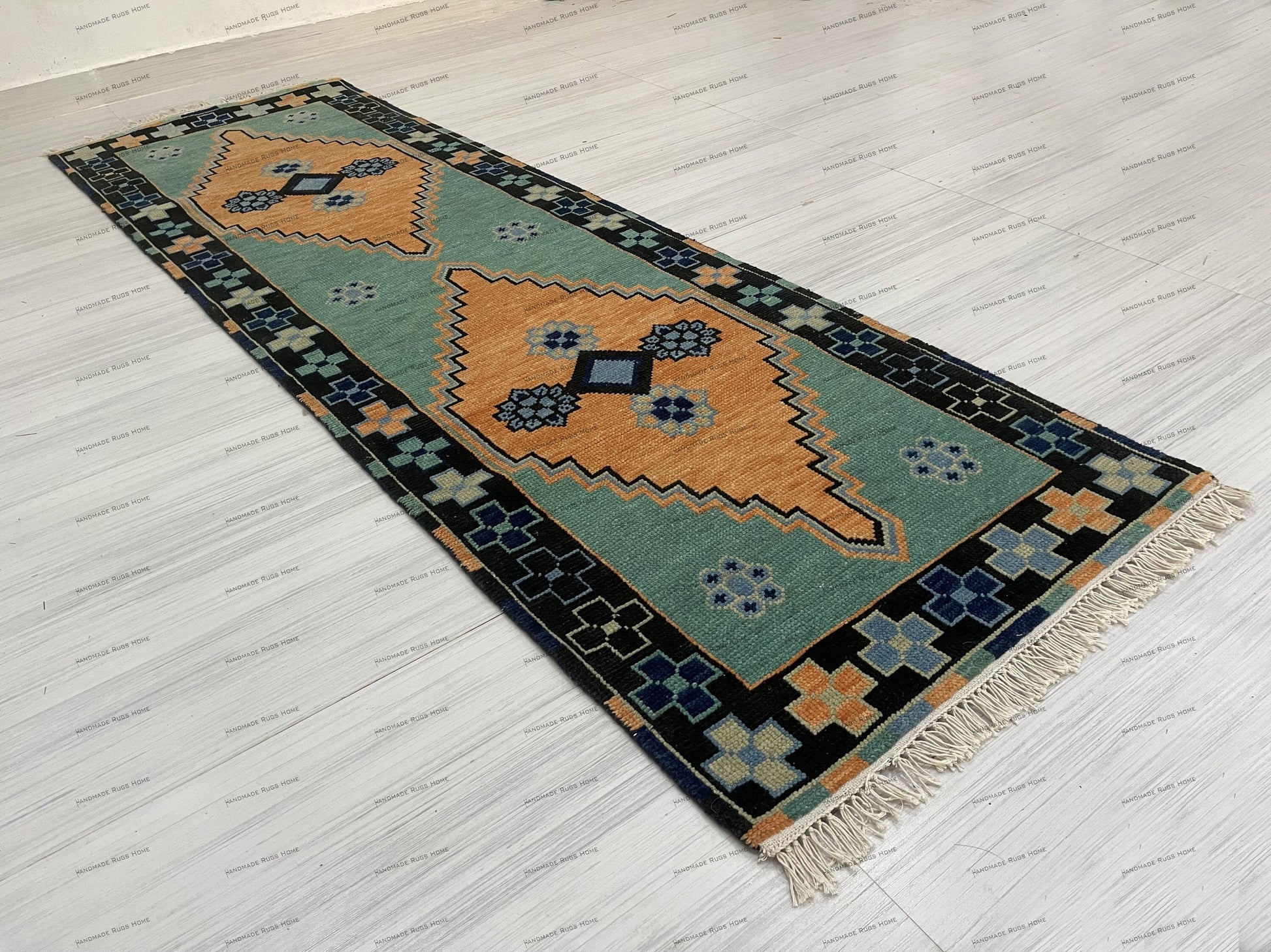 Luxurious hand-knotted rug with soft orange hues and delicate flowers.