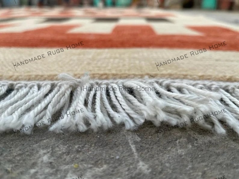 Boho-style handmade rug with bold red and black linear designs.