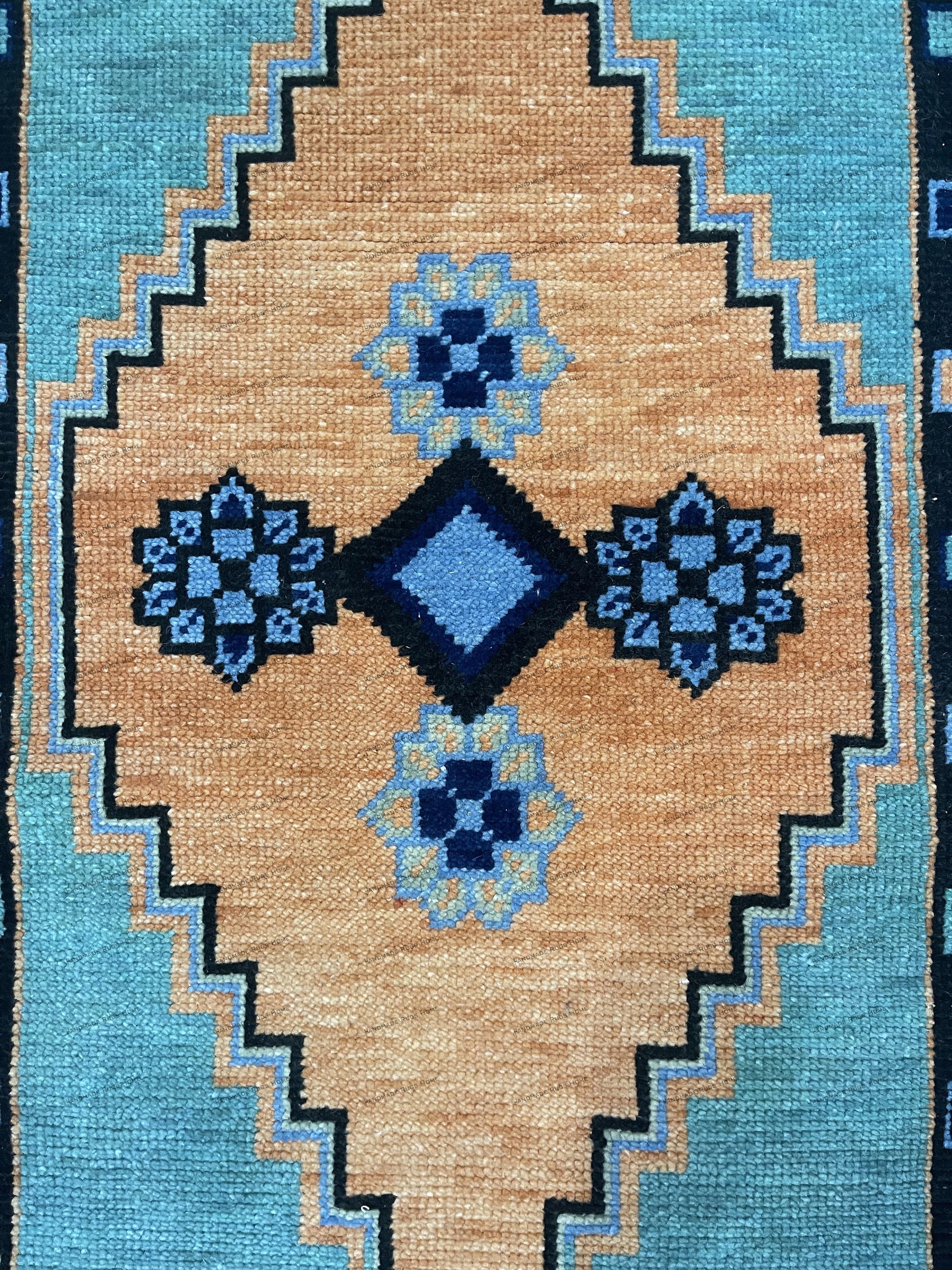Luxurious floral rug in orange, accented with blue and beige details.