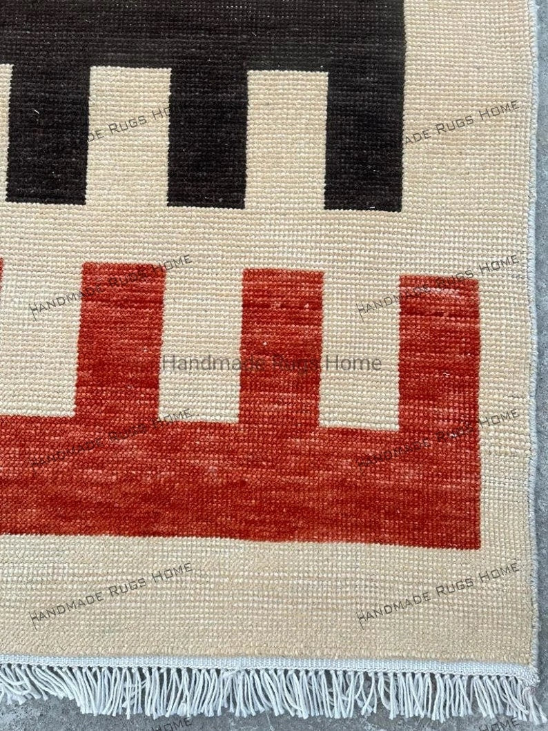 Statement rug featuring geometric patterns and warm earthy hues.