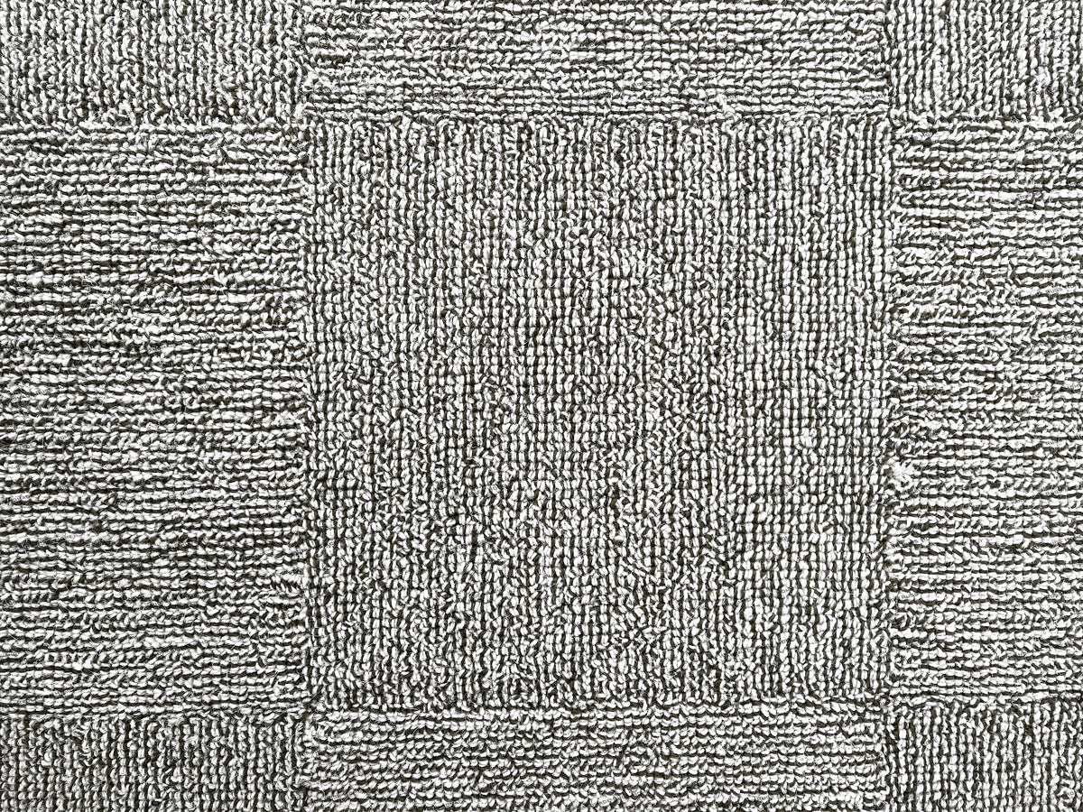 Unique modern rug with hand-tufted patterns in warm and cool tones.