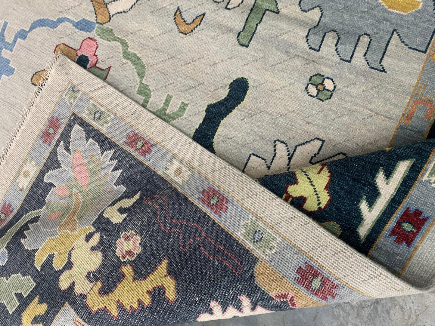 The rug is placed on a polished wooden floor, adding warmth and sophistication to the scene.