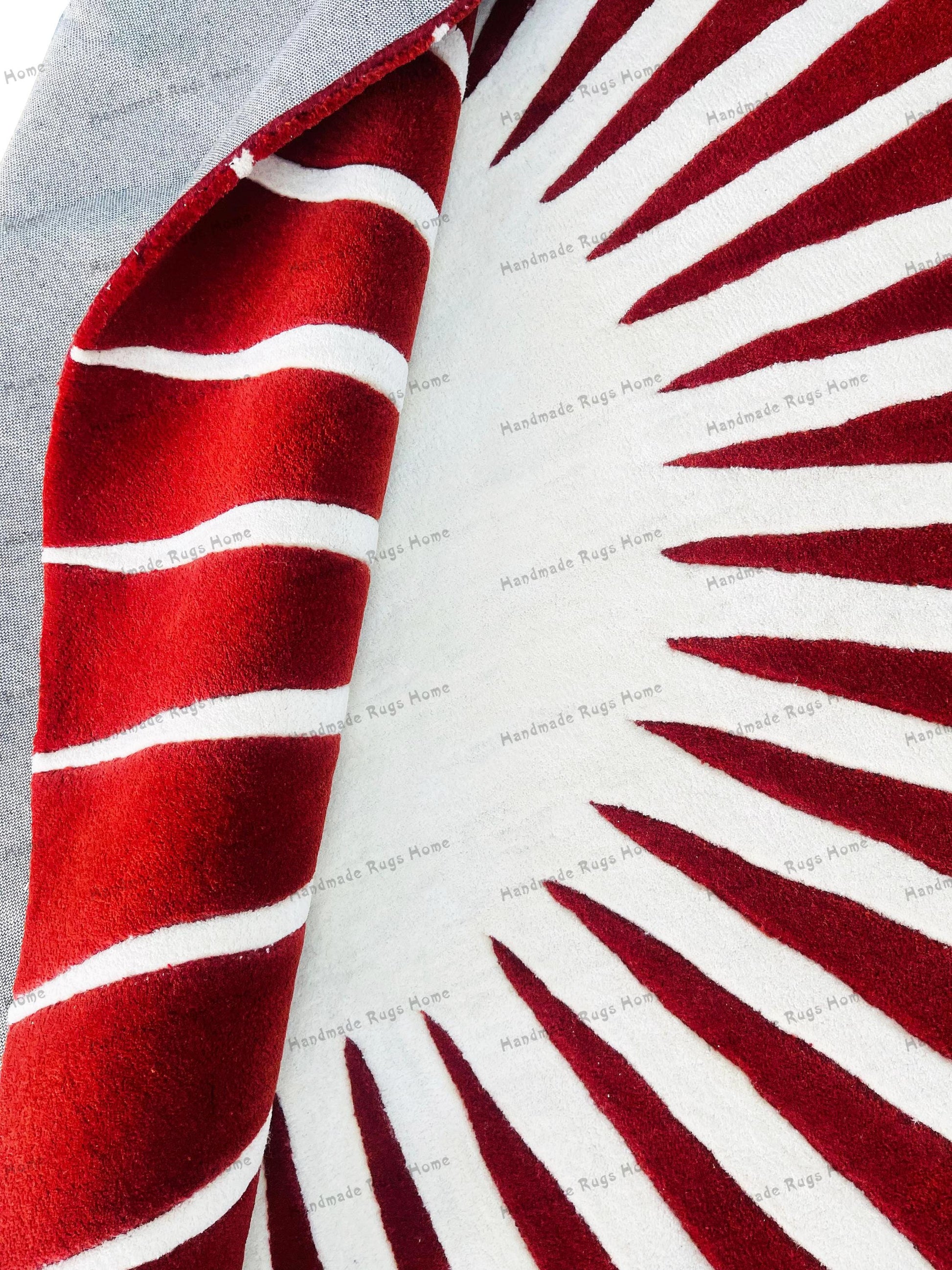 Round hand-tufted wool rug in red and white design