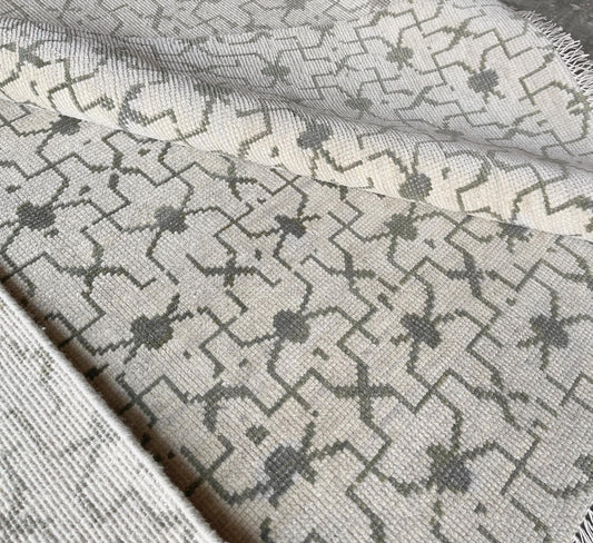 Faded Oushak rug with soft blues and yellows, perfect for modern interiors.