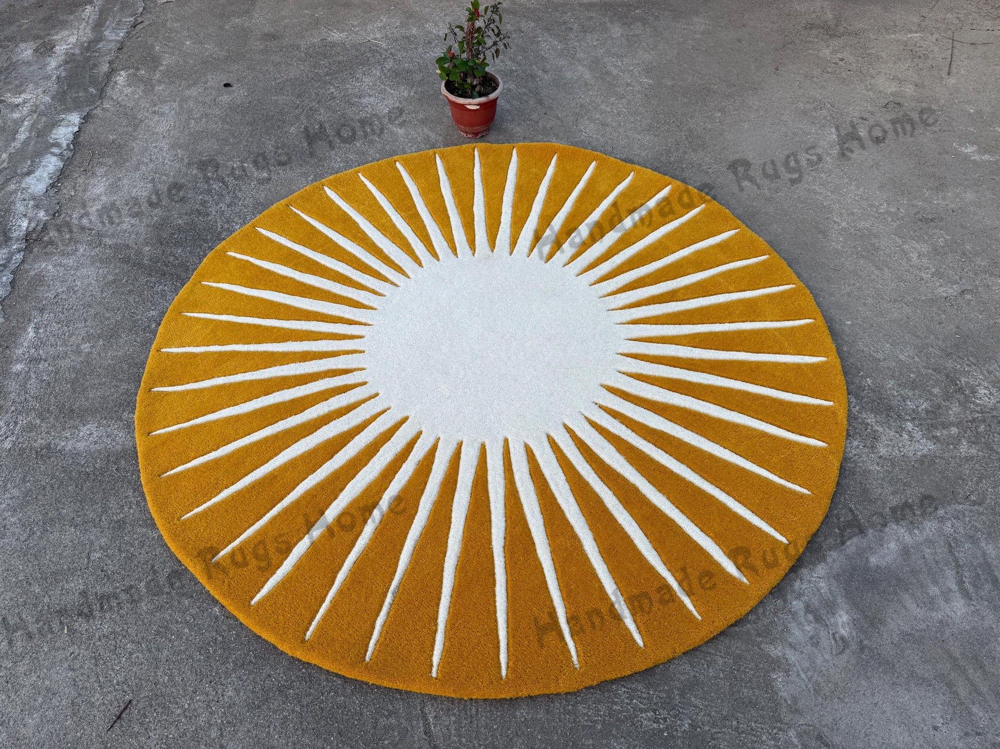 Soft, circular handmade rug featuring a sun-inspired pattern in pink and off-white, complementing the modern room decor.