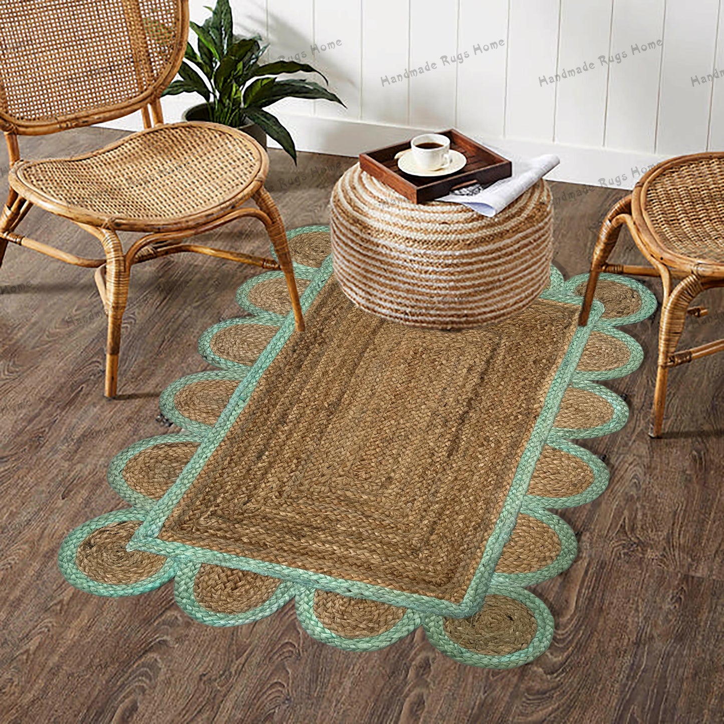 Handwoven jute rug with scalloped edges and a navy border placed in a cozy boho-style room with rattan chairs and wooden flooring."