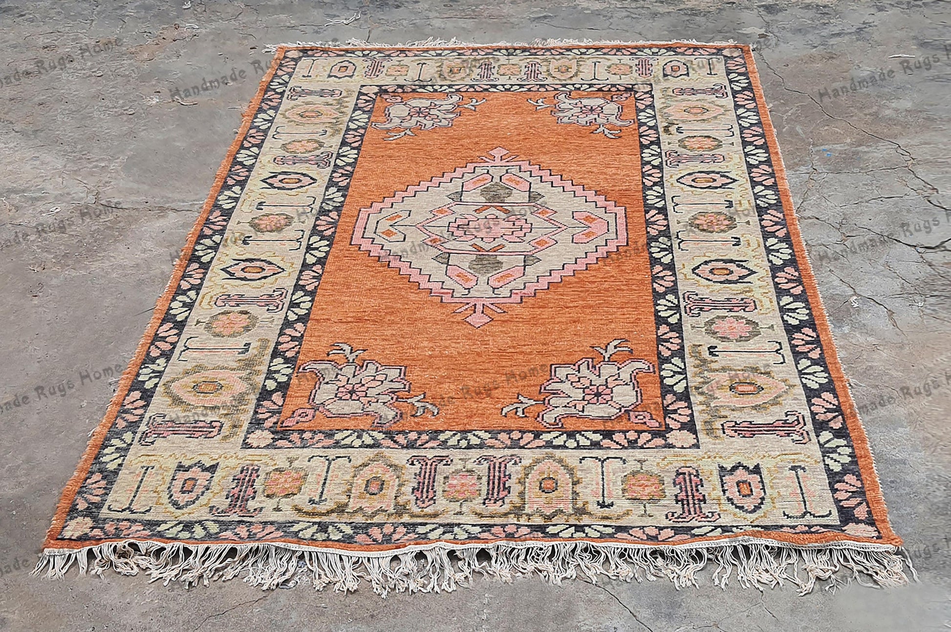 Handmade Persian-style carpet with a classic border
