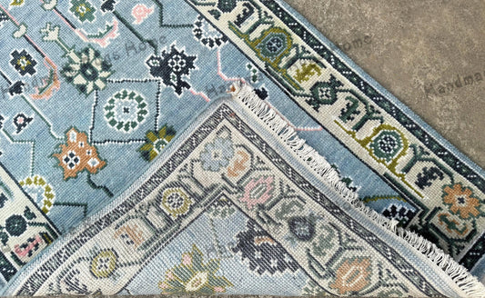 Hand knotted Turkish Oushak rug in a beautiful colorful pattern, perfect for adding warmth to any room.