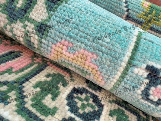 Authentic Turkish-style Oushak rug with pastel floral motifs and fringed edges.