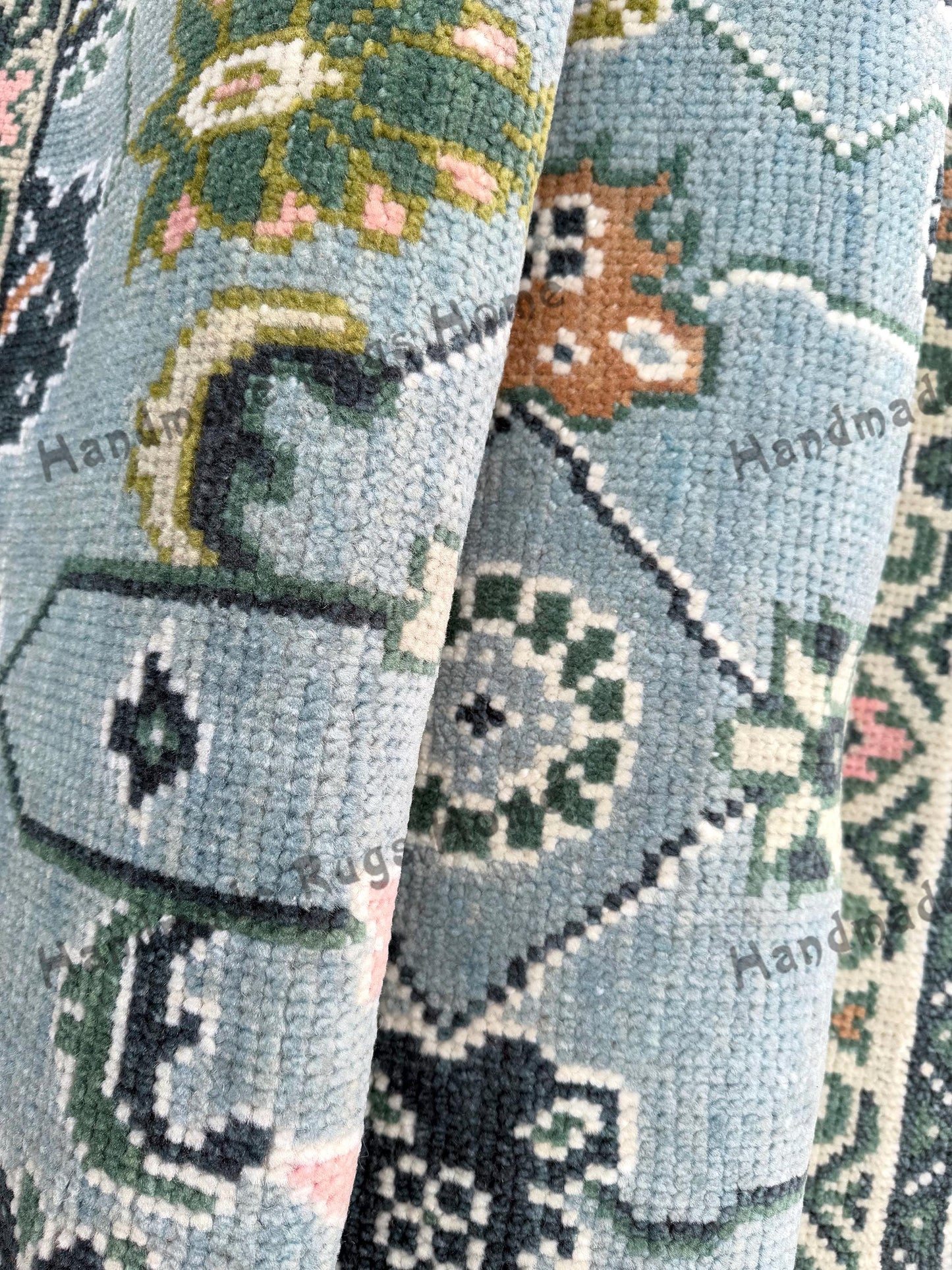 Handmade wool Oushak rug with green and turquoise tones, ideal for boho interiors.