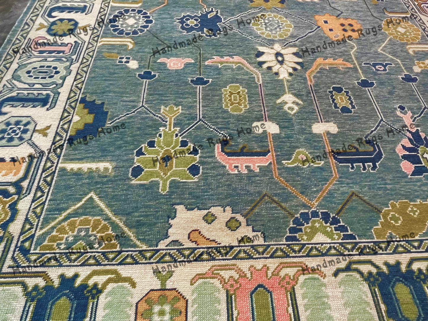 Soft wool Oushak rug with geometric designs.