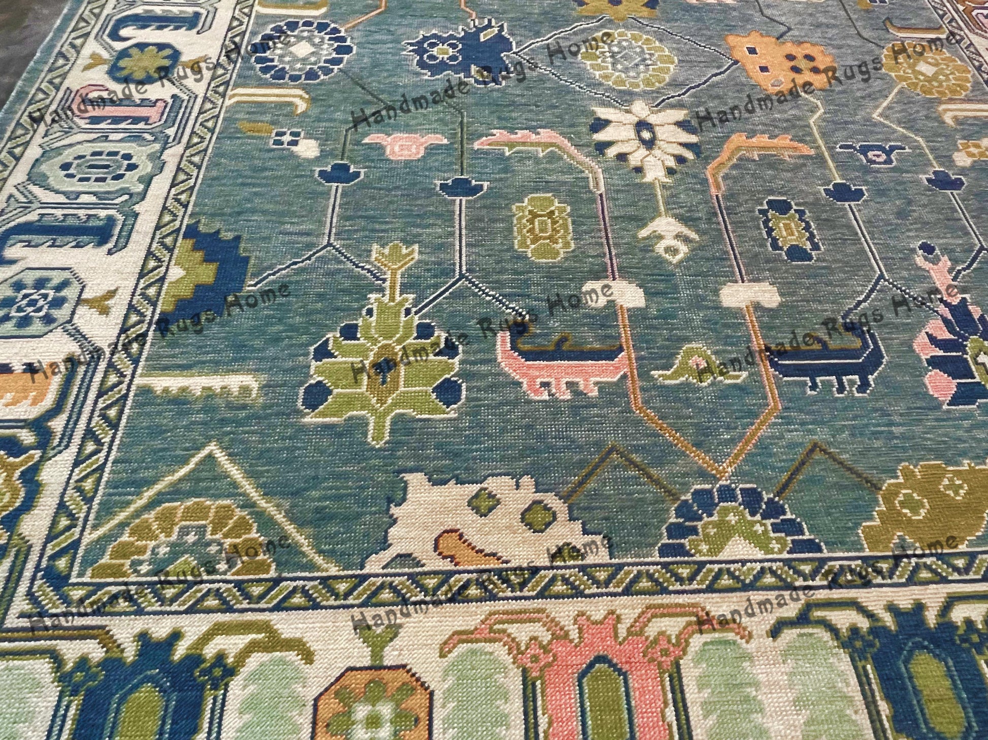 Soft wool Oushak rug with geometric designs.