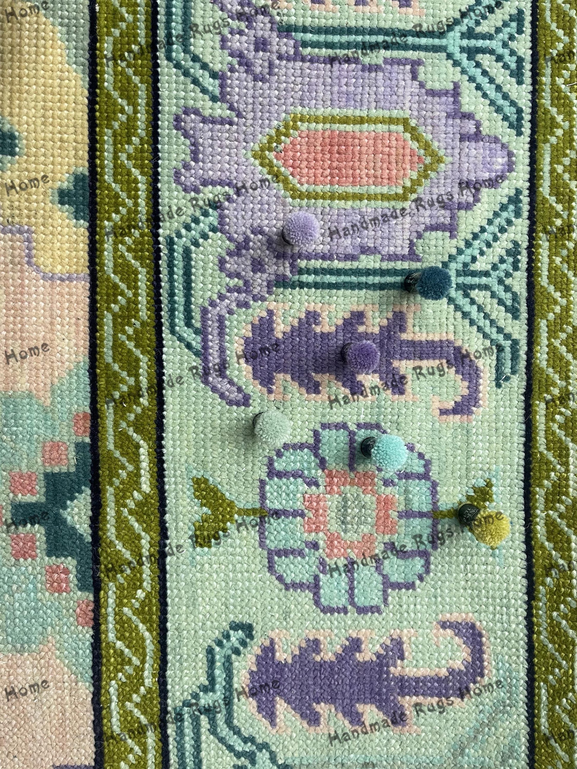 Traditional Oushak rug with pastel color tones and decorative patterns.