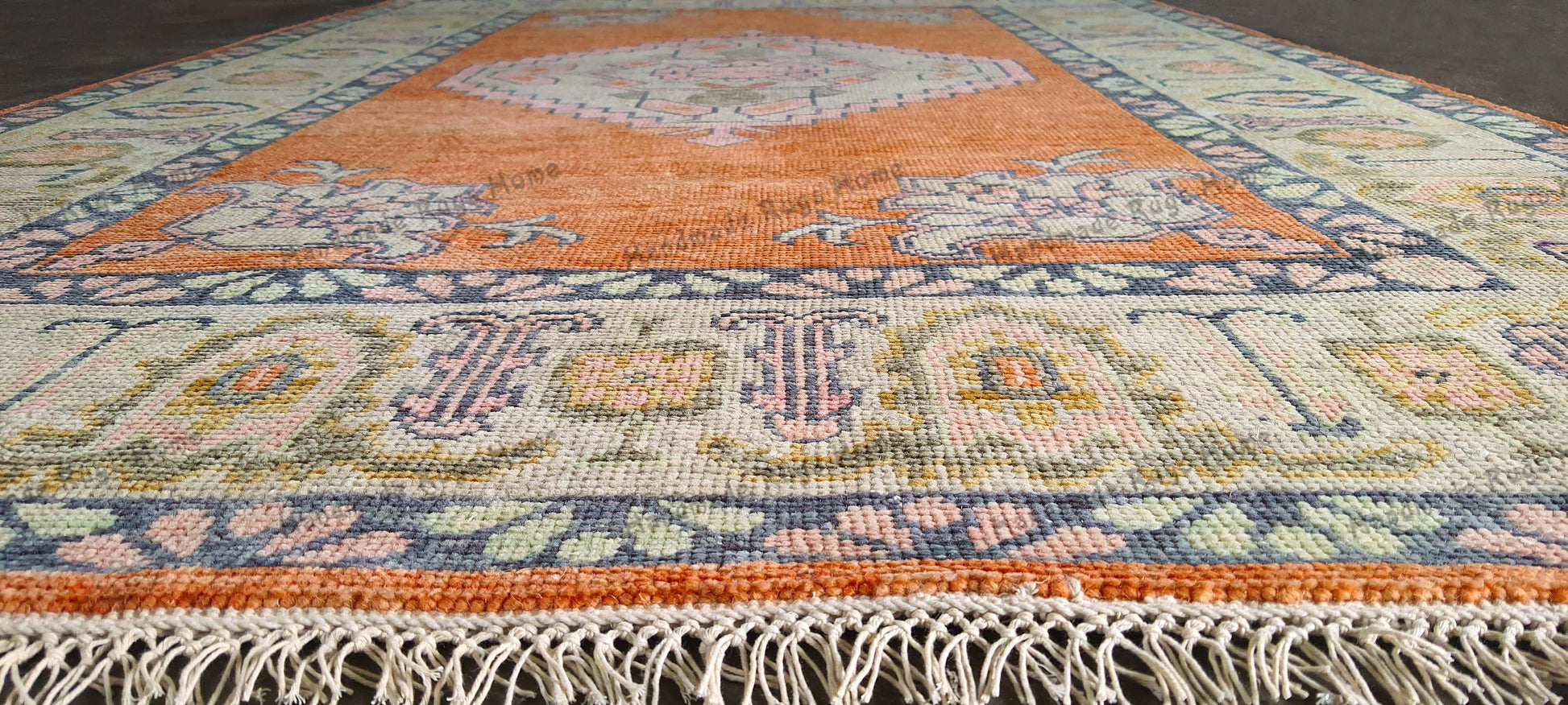 Living room rug with a warm orange and cream palette