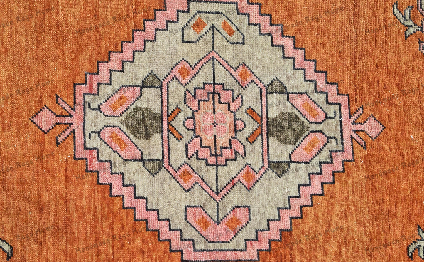 Antique-inspired Turkish rug with soft pink accents