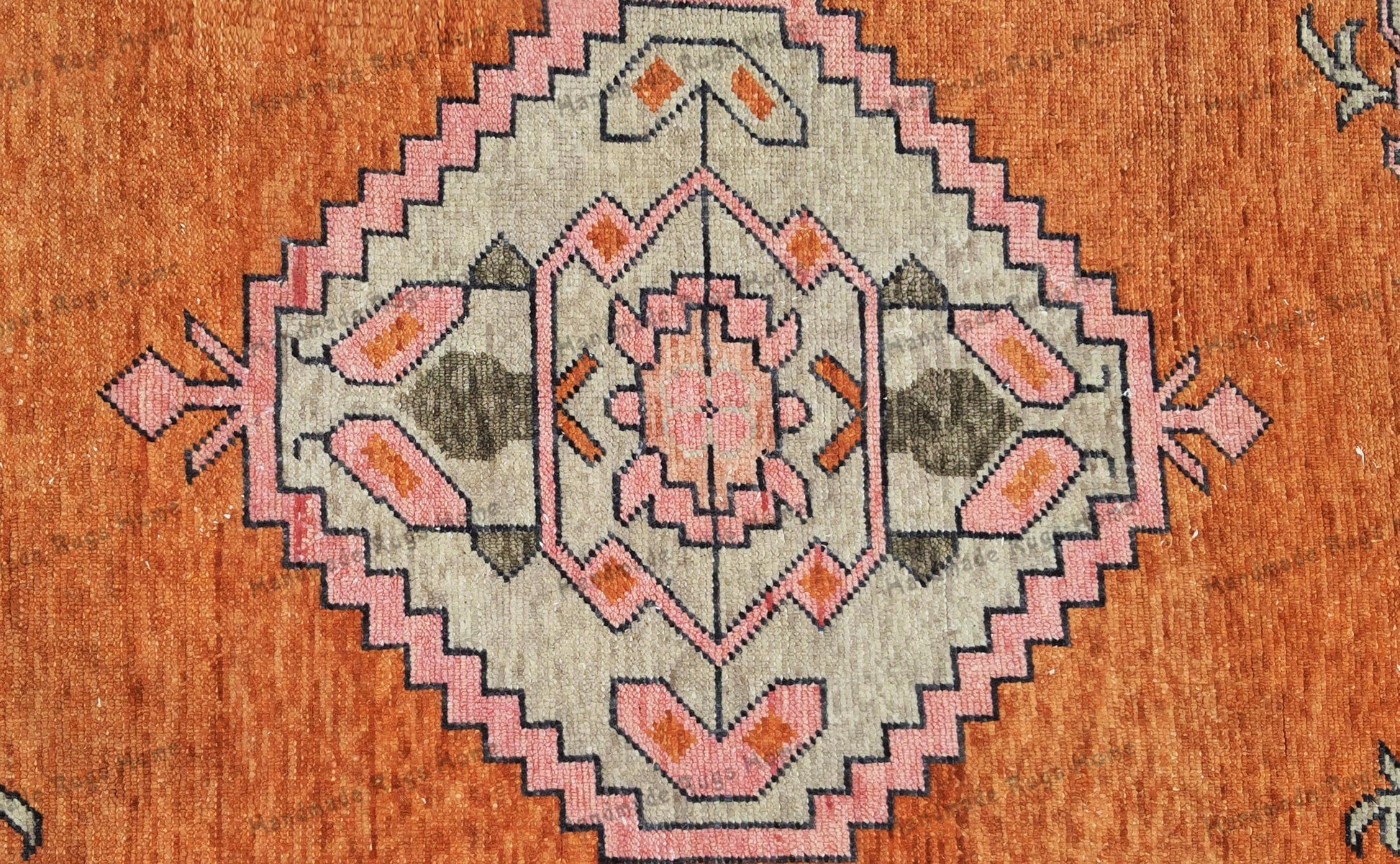 Antique-inspired Turkish rug with soft pink accents
