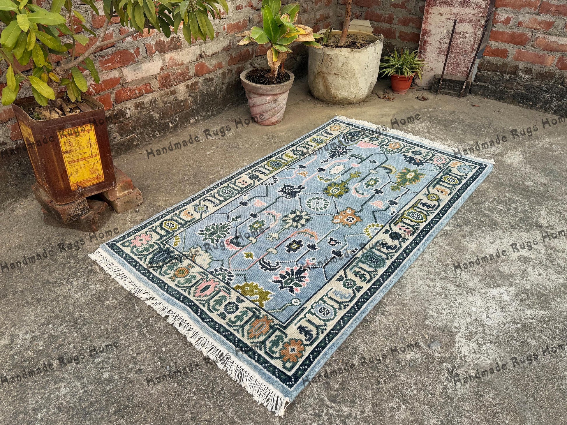 Vintage-inspired Oushak rug with soft teal hues and handwoven charm.