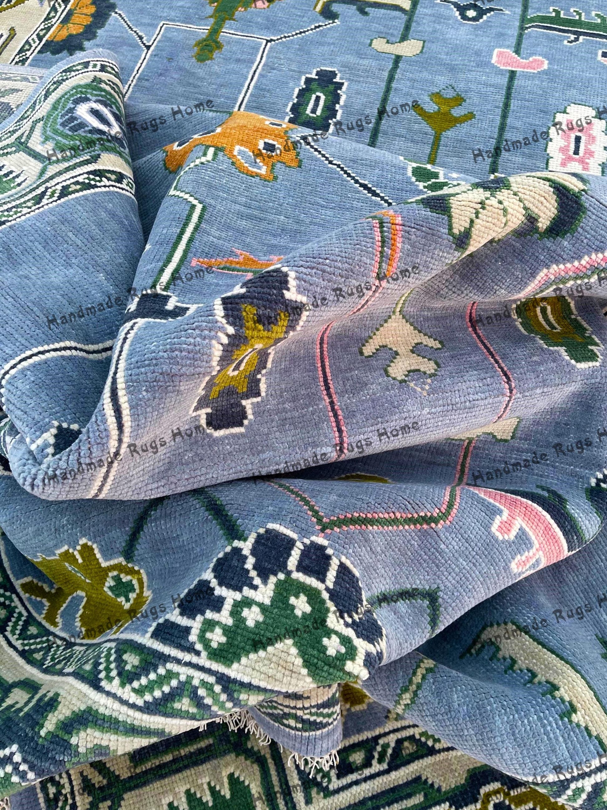 A beautiful hand-knotted blue geometric rug with intricate designs.
