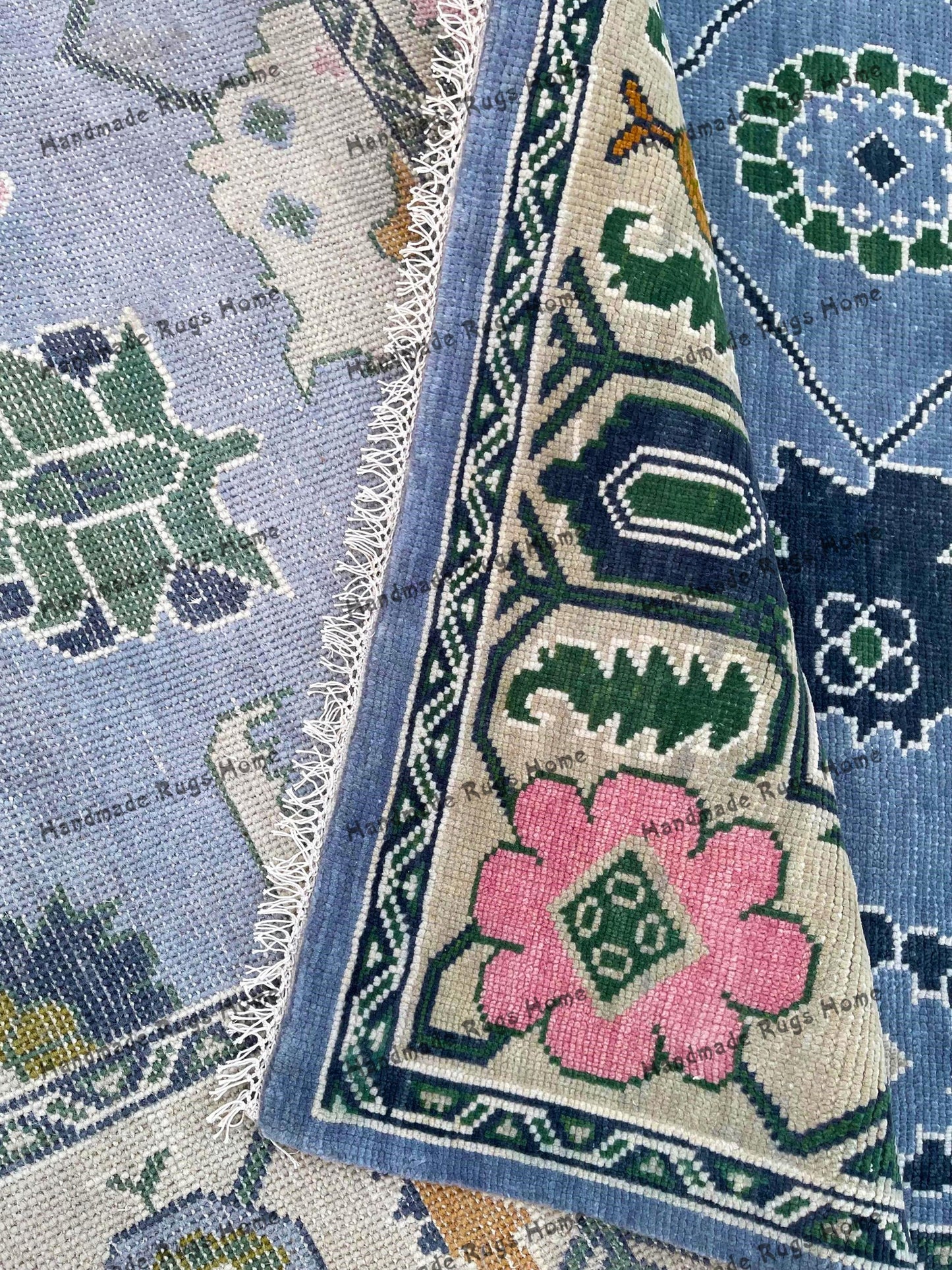 Handmade wool area rug in blue with boho tribal patterns.