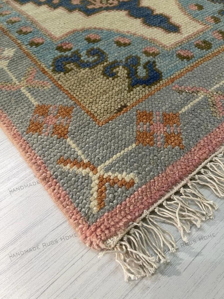Vibrant handmade area rug with cream and multicolor patterns in a classic interior.