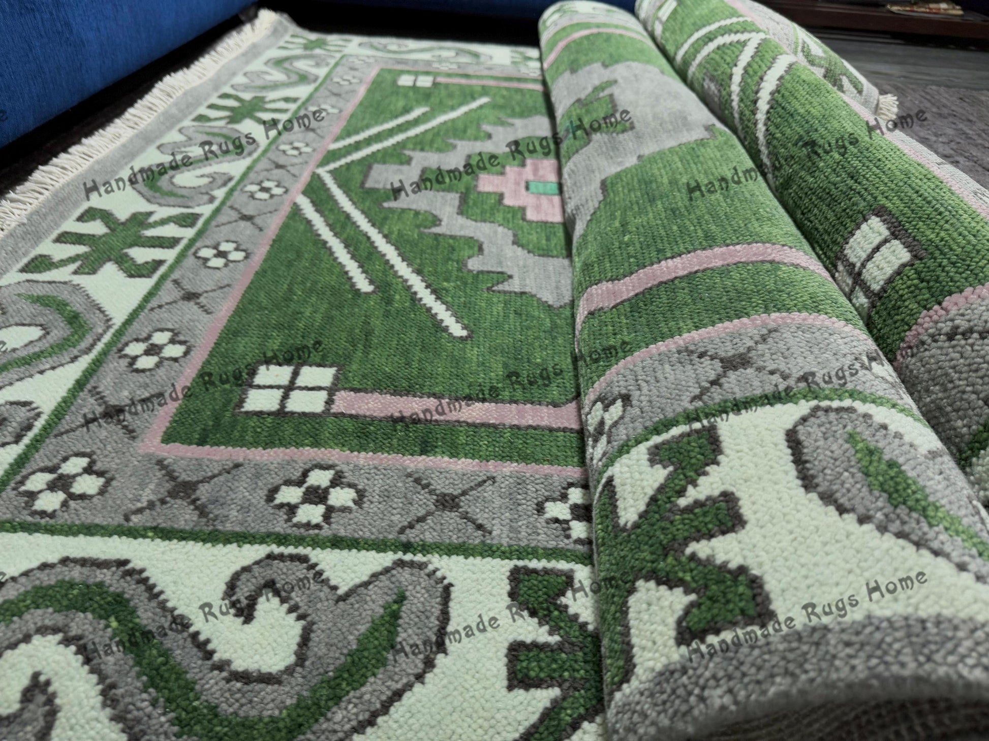 Traditional green Oushak carpet with intricate pink and grey accents.
