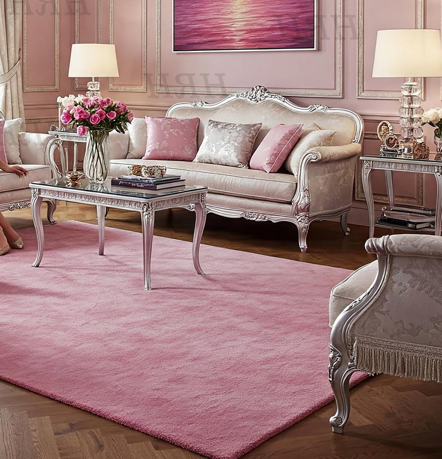 Light pink area rug under glass coffee table