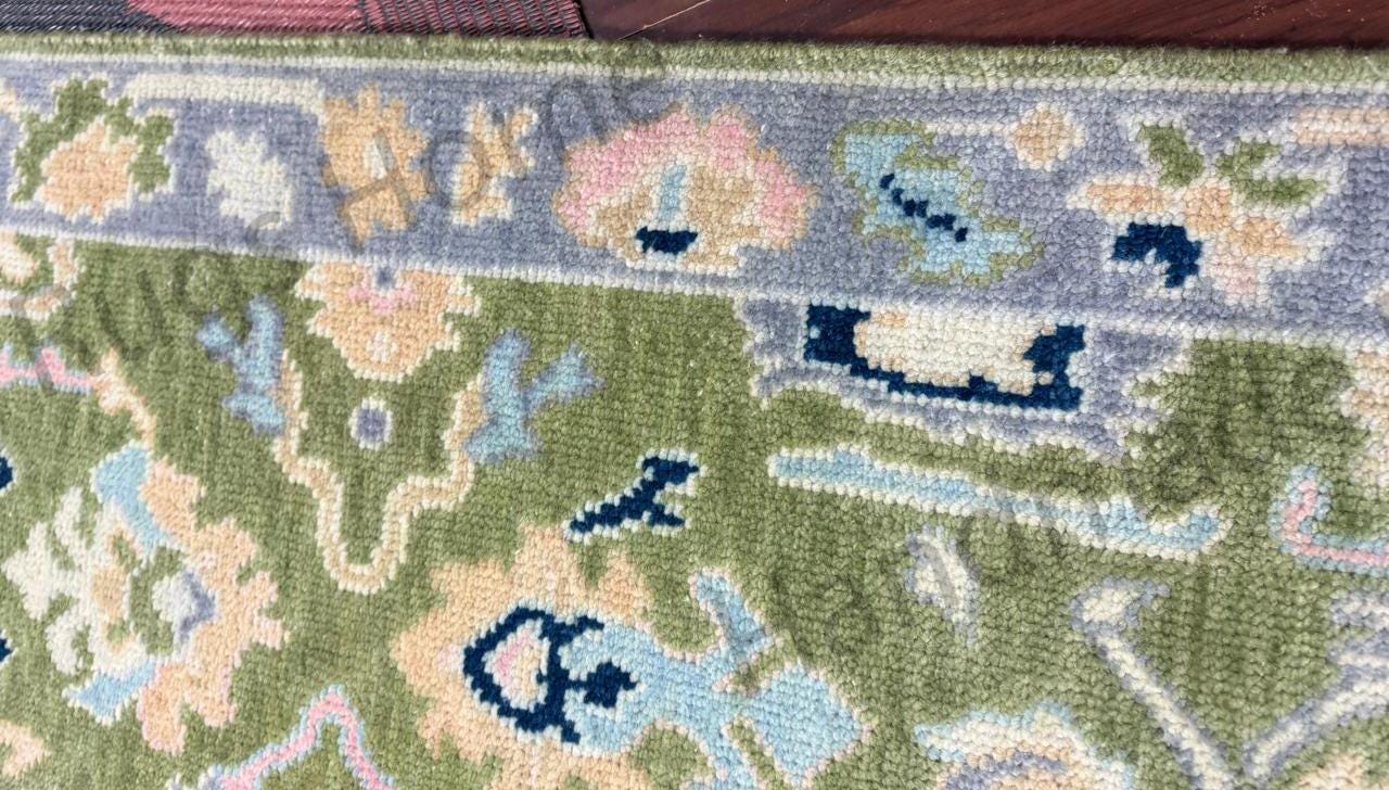 Traditional Oushak rug with floral motifs.