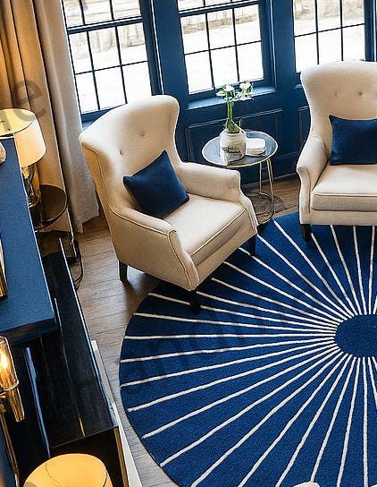 Stylish living room featuring a 'Radiant Midnight Sun' hand-tufted wool rug.