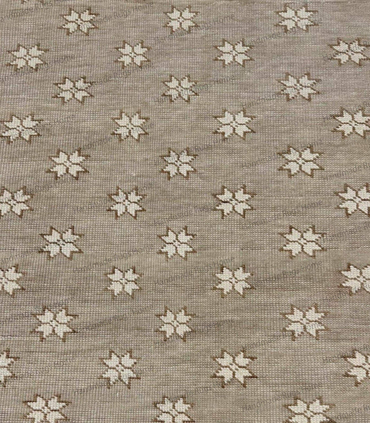 Modern Scandinavian-style floor rug with a beige backdrop and decorative floral/star accents.