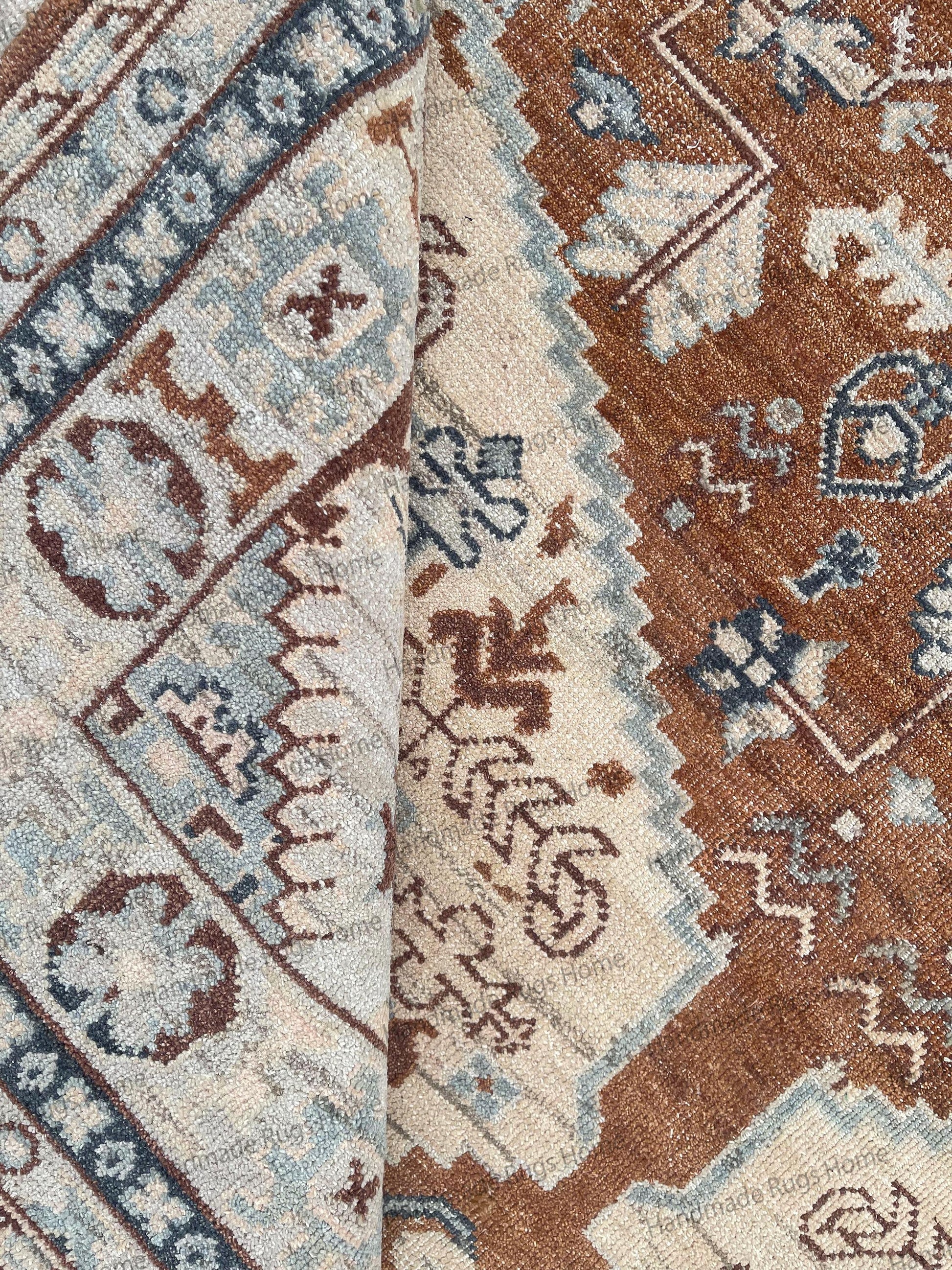 Soft beige and pale blue Oushak floor covering in a spacious living room.