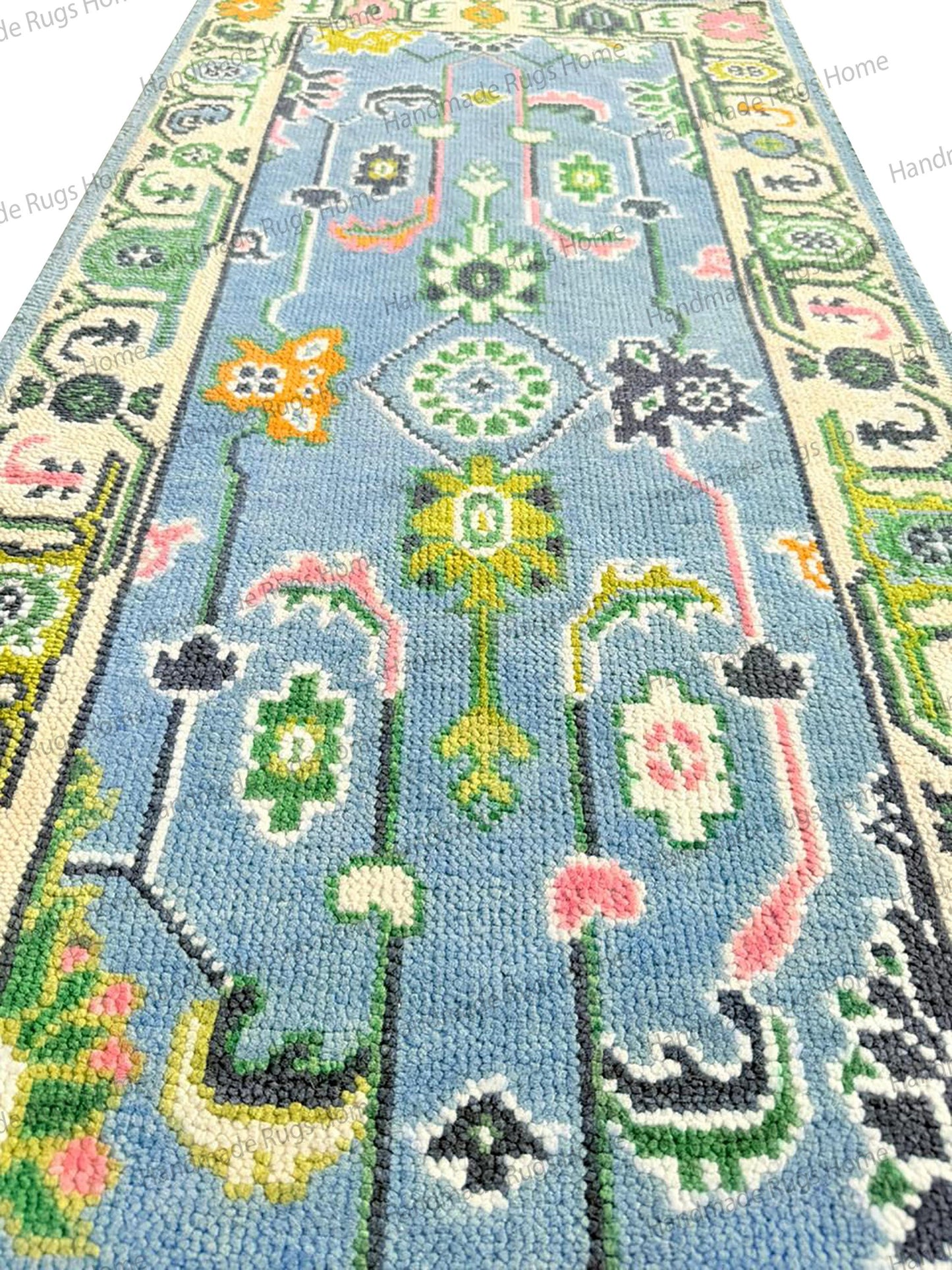 Traditional light blue and pink wool floor carpet. This large rectangular rug features an Oriental floral design for high-traffic spaces.
