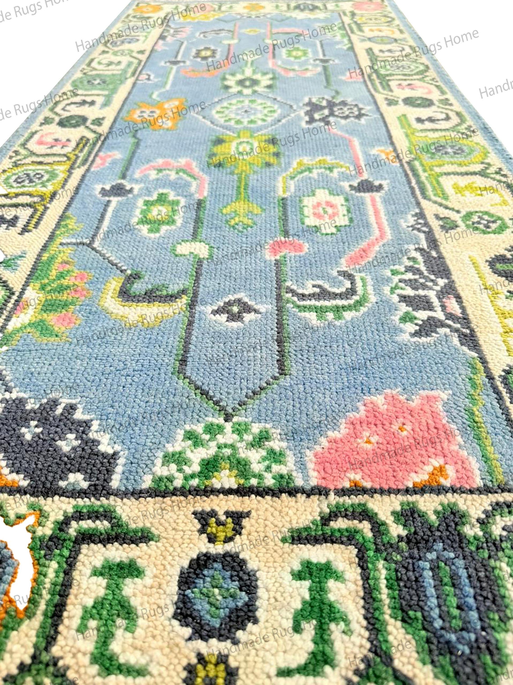 Sky Blue Transitional rug, 100% natural wool construction, detailed handmade finish with bold pink and green stylized blossoms.