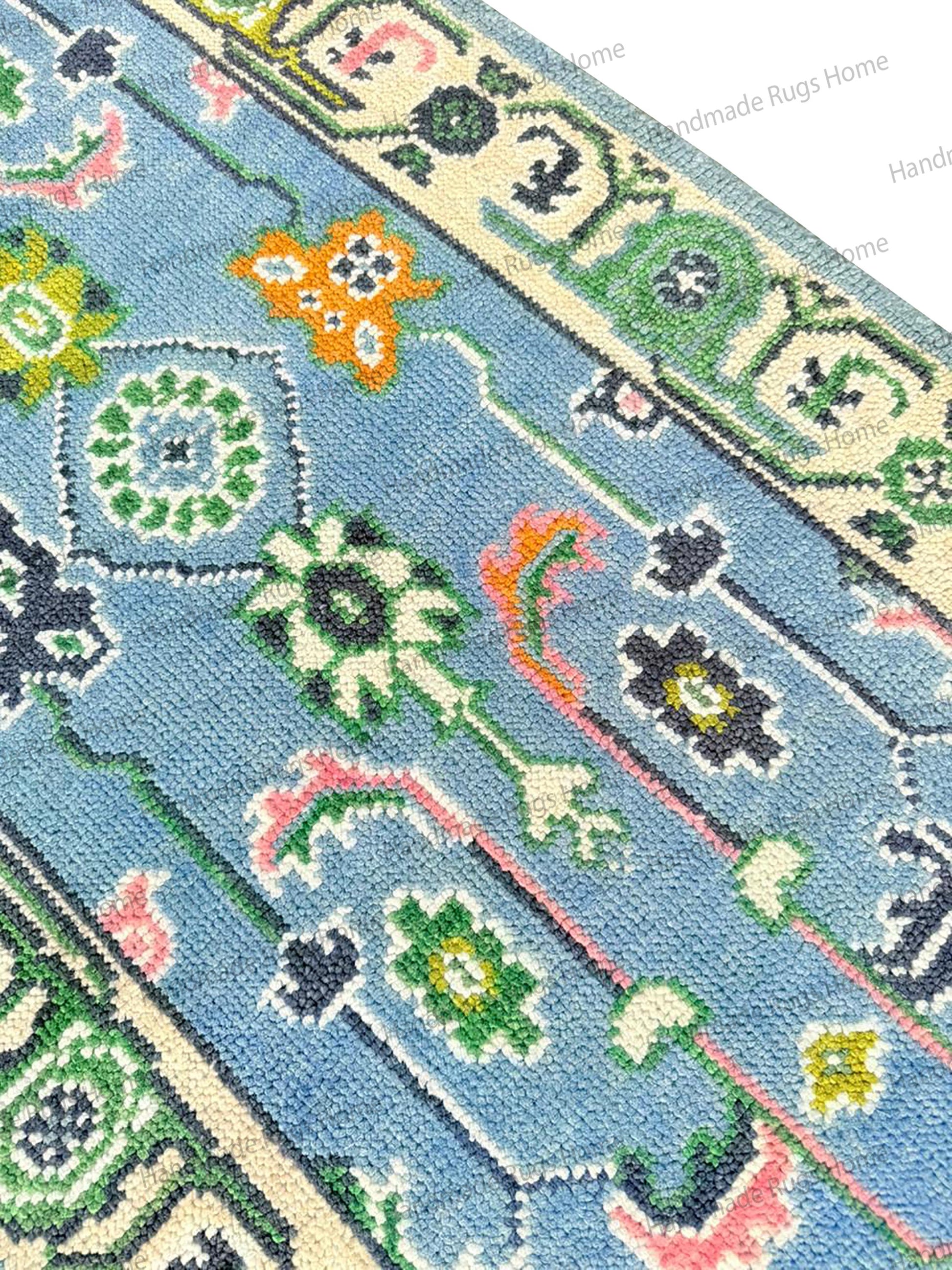 Rectangular multicolor wool carpet with a dominant soft blue field, ideal for bedroom or dining room decor. Oushak pattern.