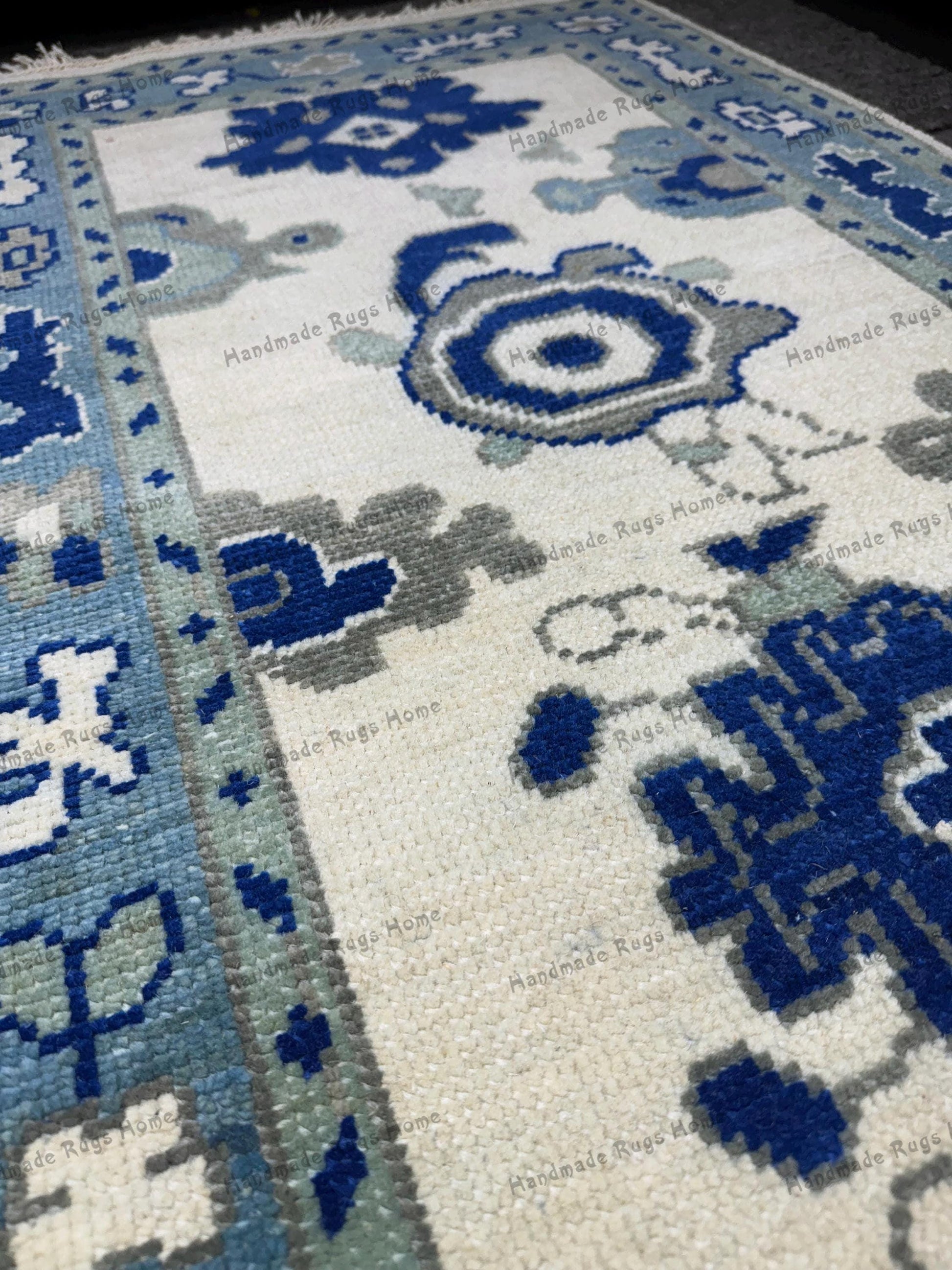 Custom wool rug with vibrant blue geometric designs.