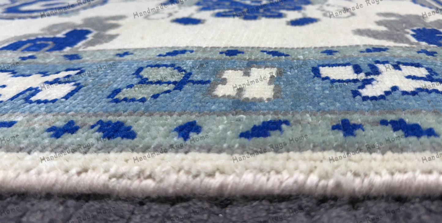 Artisan-crafted rug with bold blue floral patterns.