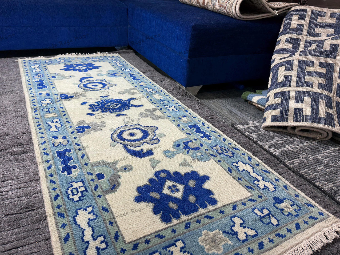 Decorative blue and cream rug with fringes.