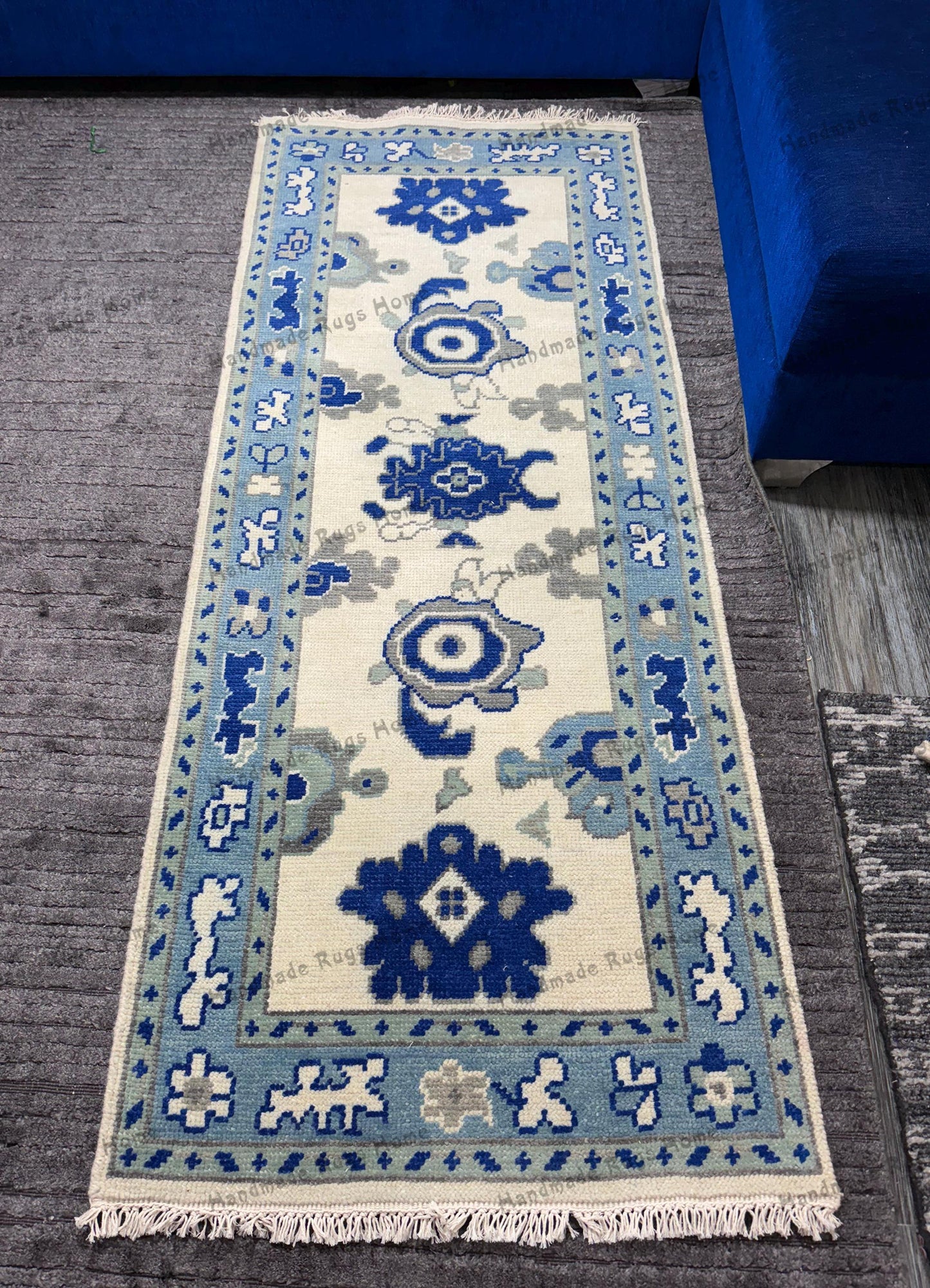 Handmade blue and white rug with intricate patterns.