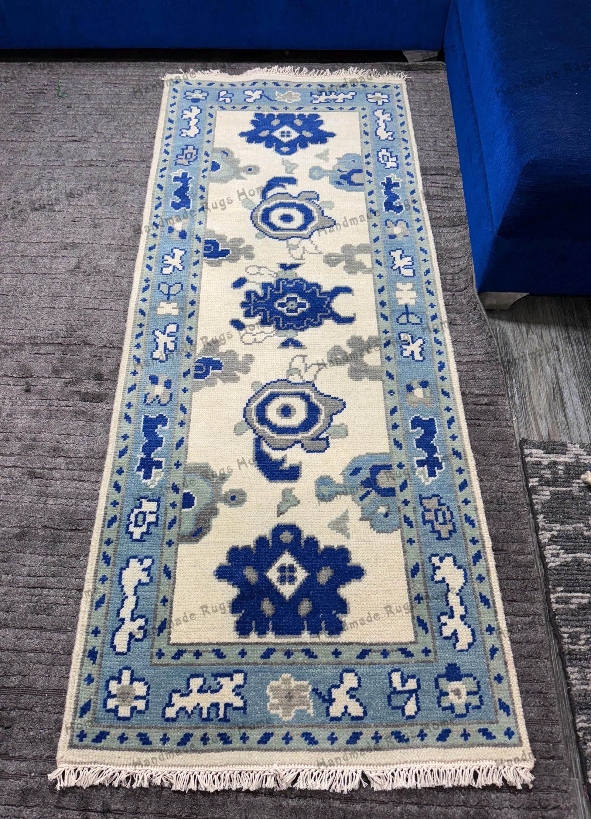 Handmade blue and white rug with intricate patterns.