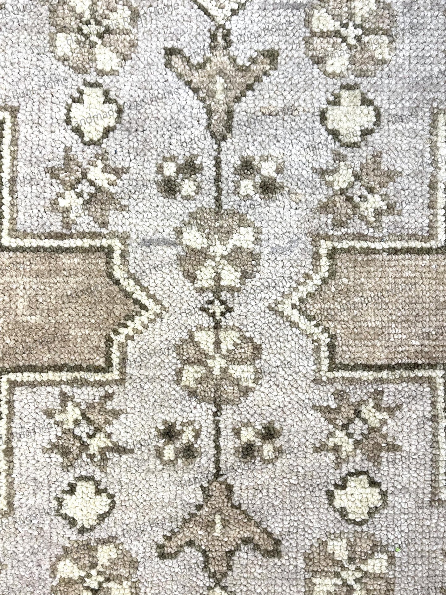 Unique handmade carpet with a gray and brown color mix and geometric motifs.