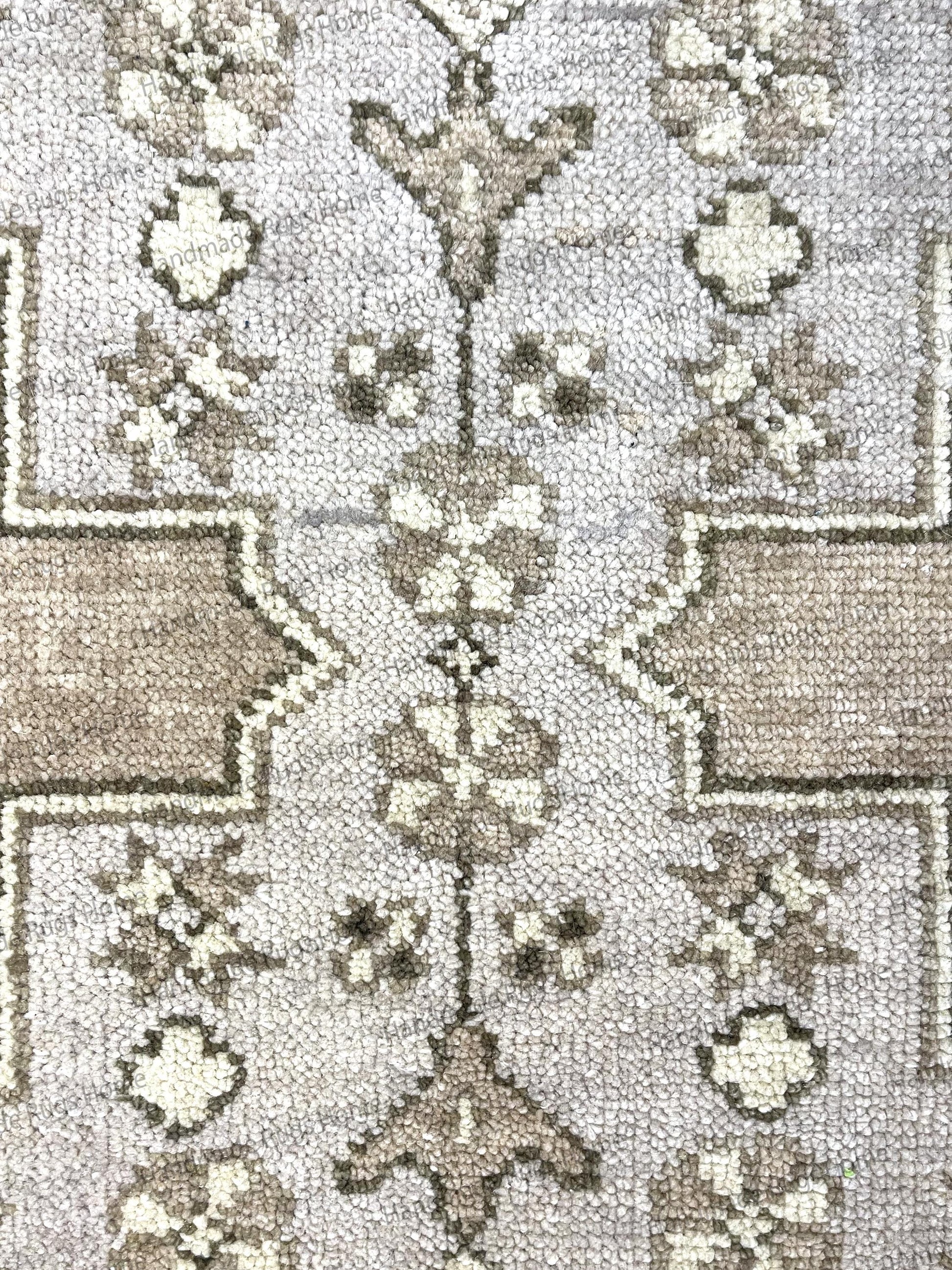 Unique handmade carpet with a gray and brown color mix and geometric motifs.