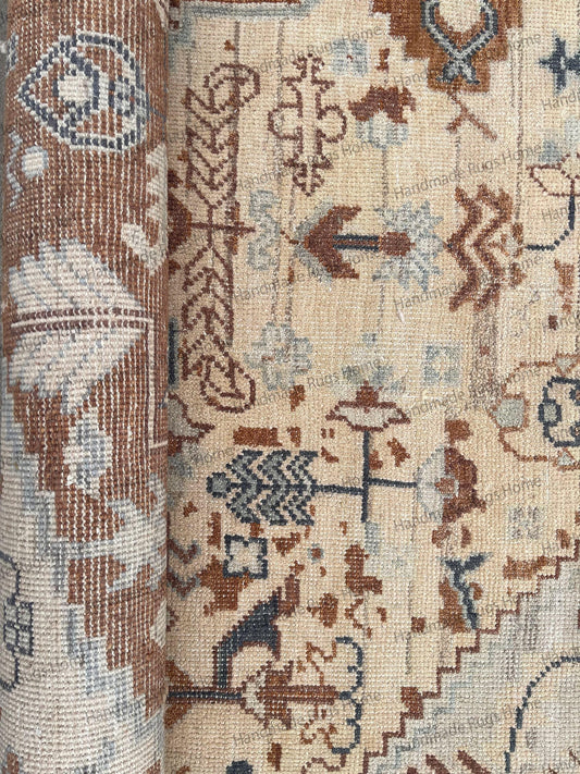 Hand-knotted Oushak wool rug in ivory, beige, and muted blue.